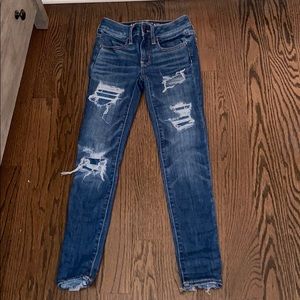 Dark blue ripped jeans.